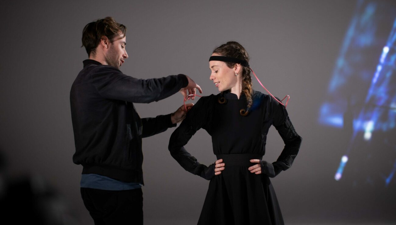 Chris Panzetta from creative technology agency fits a motion capture suit from Rokoko to a Naomi Hibberd.