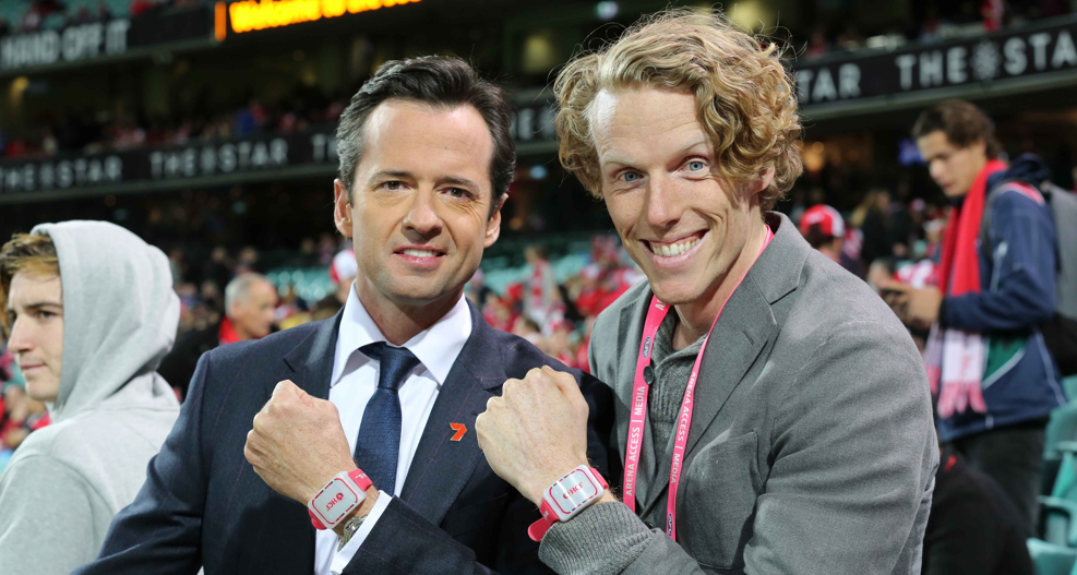 Two men wear heart monitoring wristbands as part of digital marketing agency data visualisation HCF Heart of the Swans.