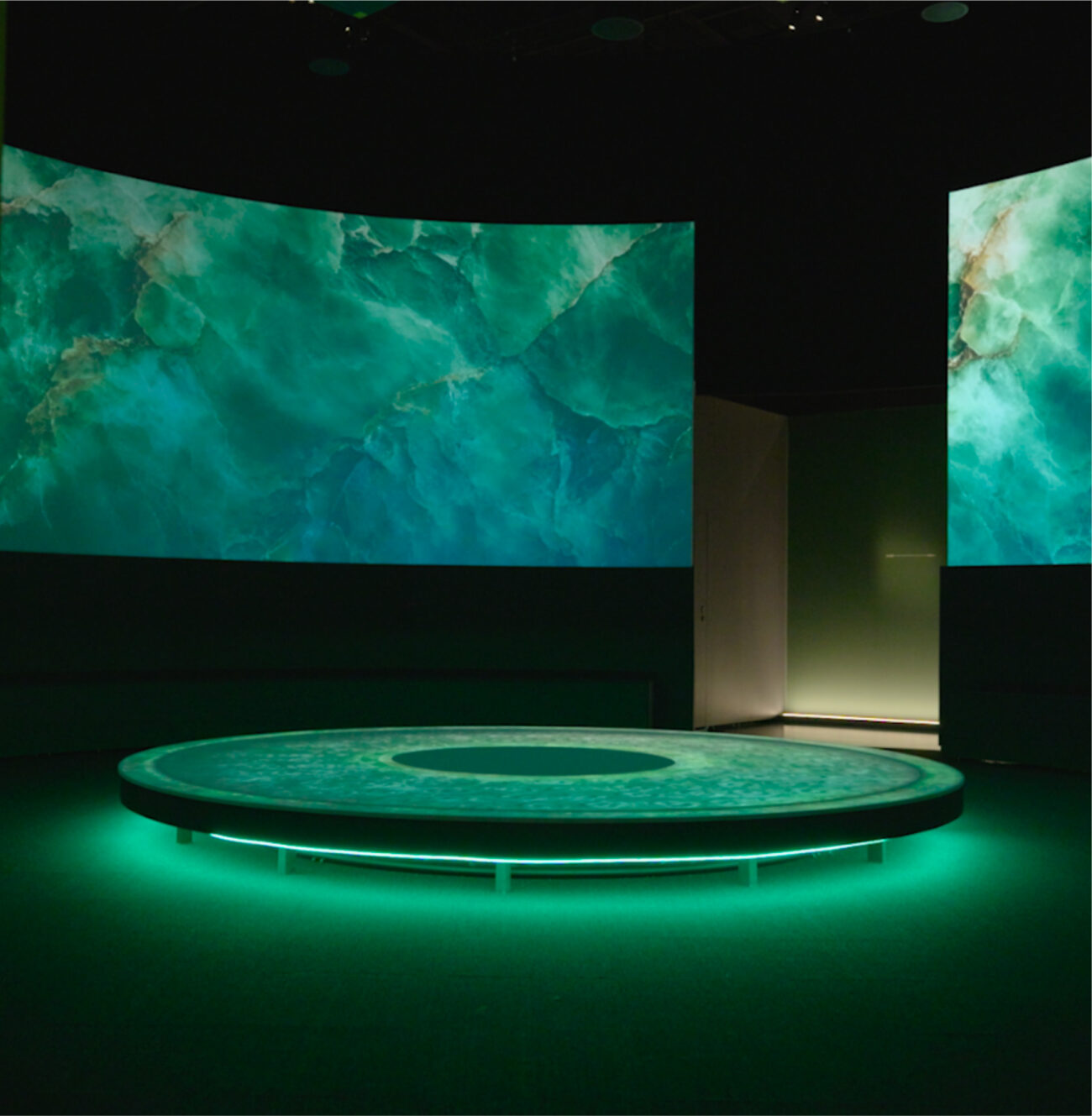 Low table projection surface and wraparound projection walls for the Terracotta Warriors opening immersive.