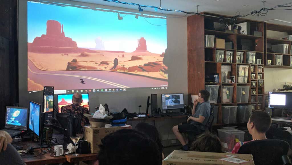 Explorer VR development team review progress on a projector.