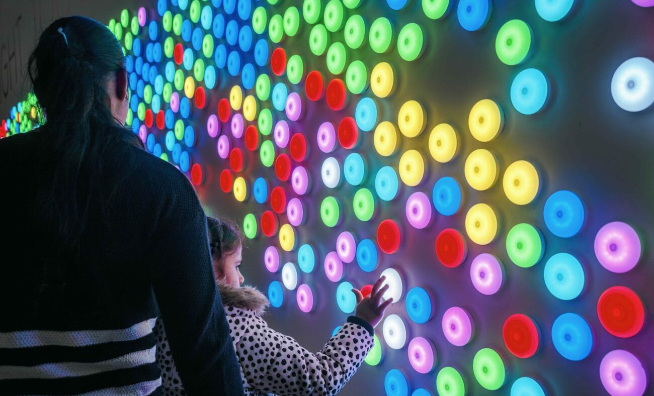 Woman and her daughter interact with a Canberra Centre light installation created by digital agency S1T2.