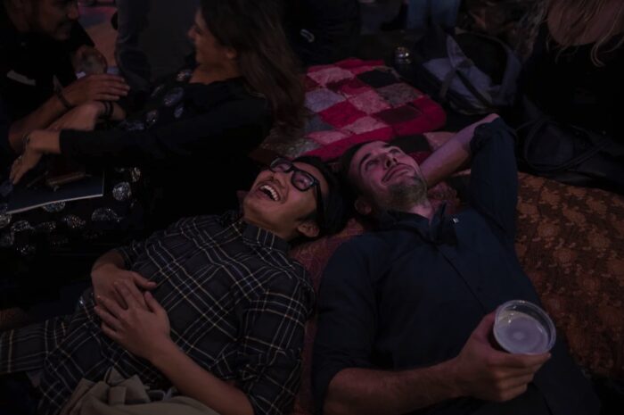 Two men lay on the floor of interactive exhibition Fables From The Threshold to experience interactive artwork Kaleidoscope Chandelier.