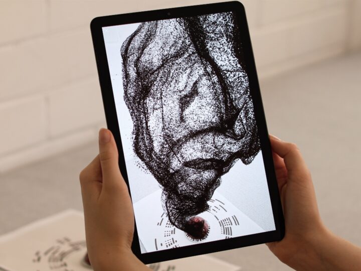 Person holds tablet with augmented reality coffee particle visualisation for Nespresso AR by creative agency S1T2.