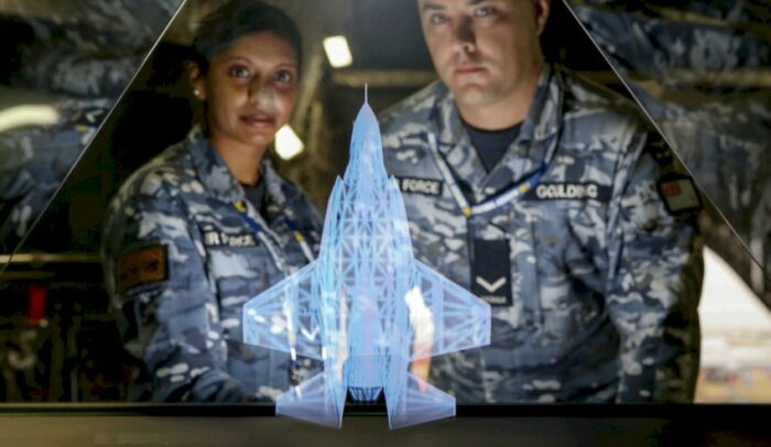 Two members of Australian Airforce stand behind Plan Jericho Hologram digital marketing activation.