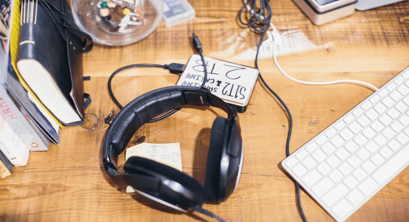 Audio headphones on a desk at S1T2.