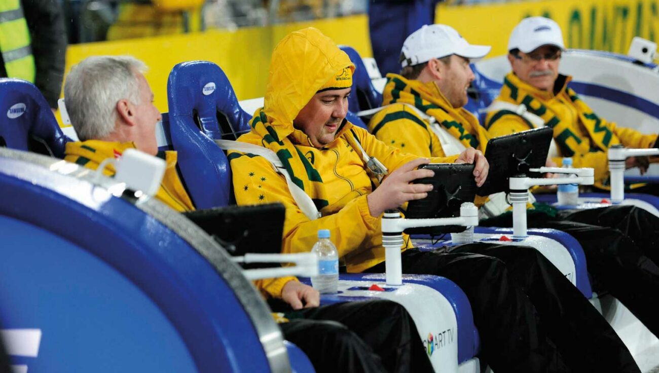 Wallabies fans sit in the Samsung SlideLiner couch while engaging with interactive tablet screens from digital marketing agency.