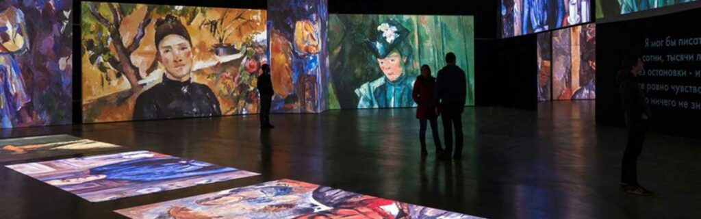 Two people admire Grande Exhibitions’ high-definition projection artworks based on the French Impressionists.