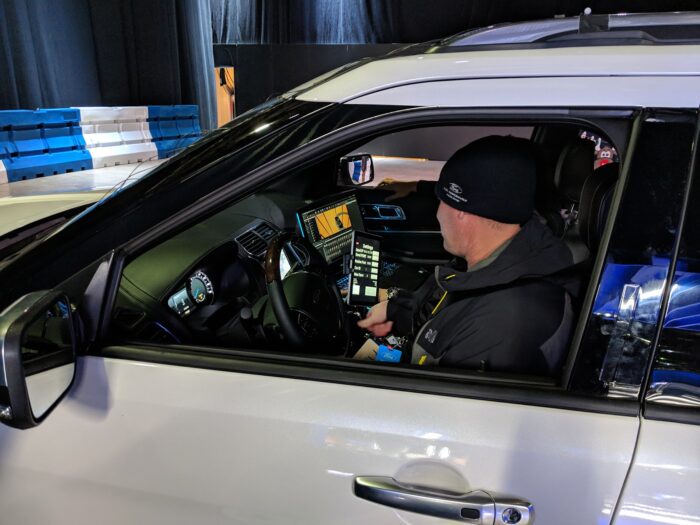 Professional driver tests an app to guide them through the Adventurer VR experience is tested on a tablet inside the SUV during deployment.