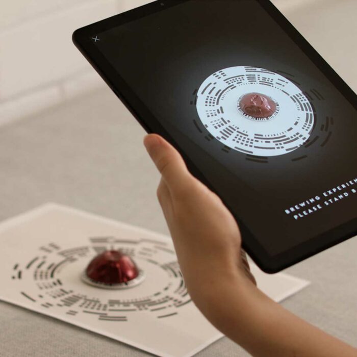 Person interacts with Nespresso augmented reality from digital marketing agency.