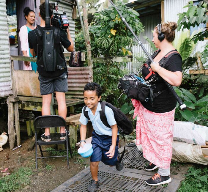 Mother and child embrace in Fijian village during filming of UNICEF Draw the Line advocacy campaign.