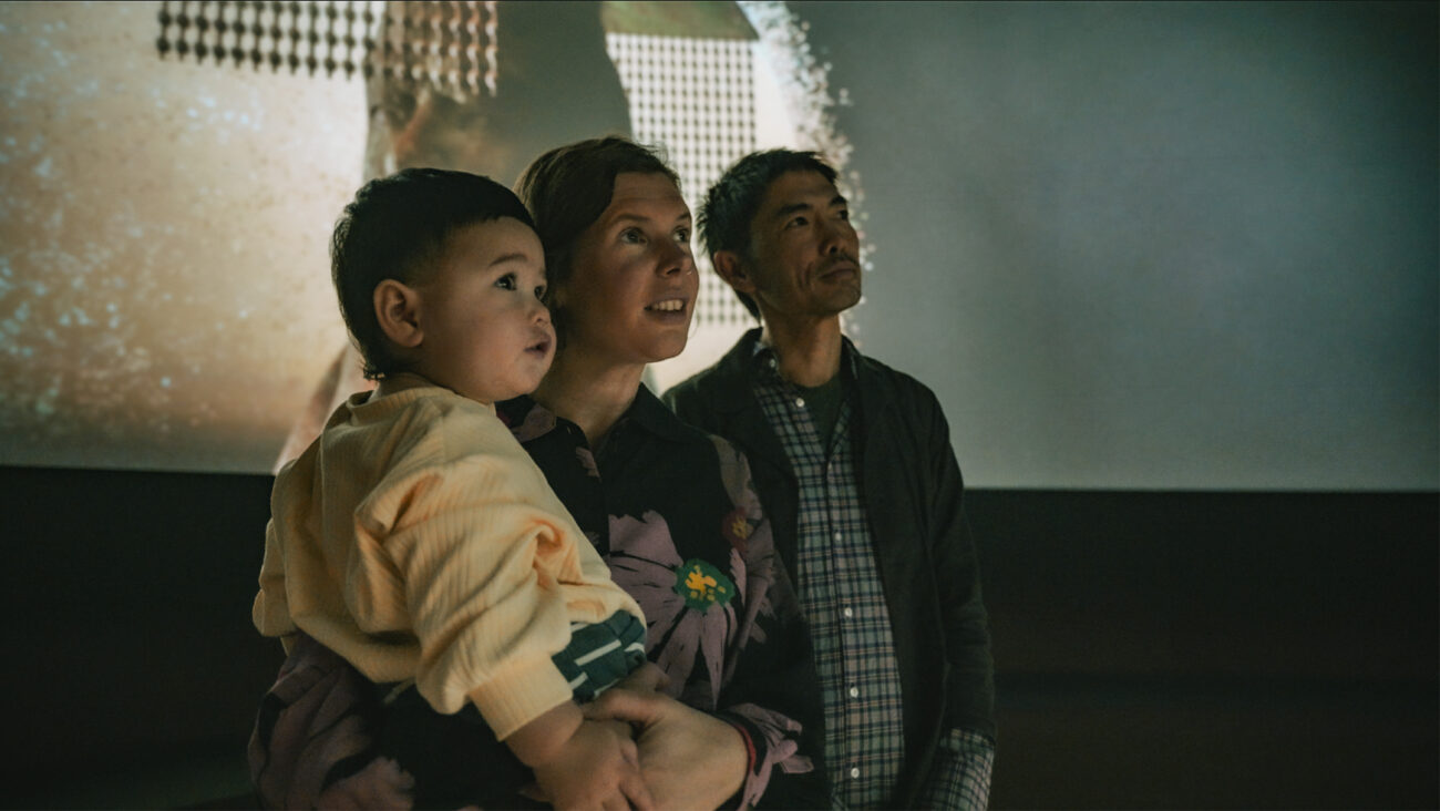 Young family stands in the opening immersive experience of Terracotta Warriors: Legacy of the First Emperor.