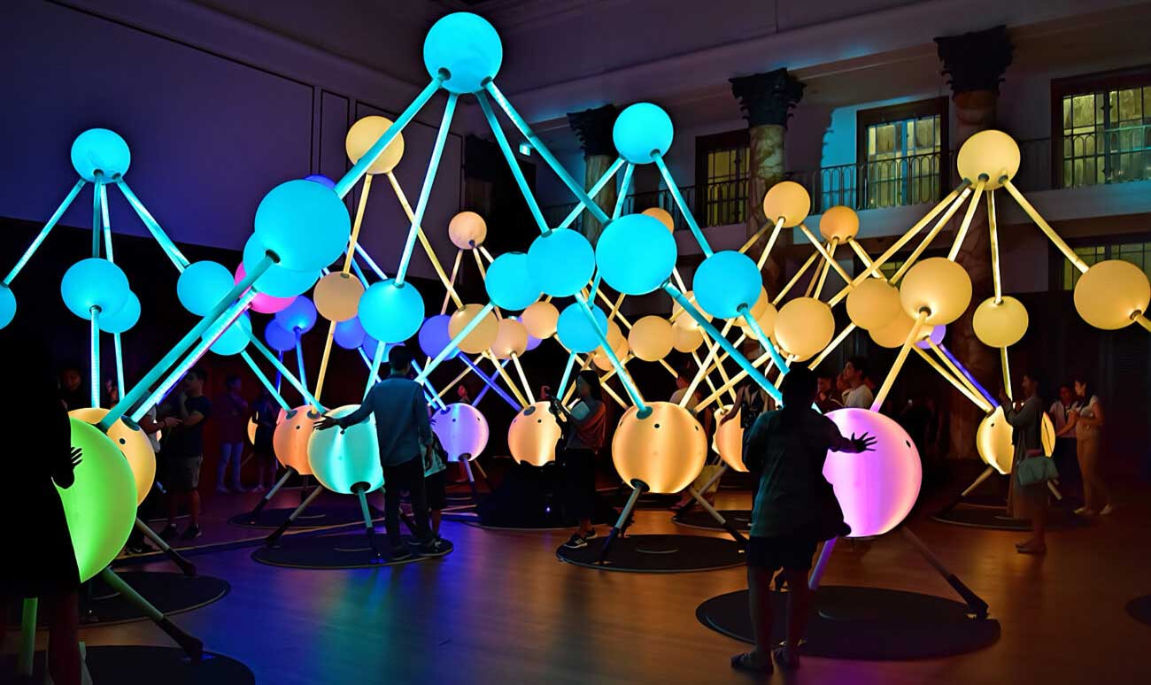 People interact with the multi-coloured interactive orbs of light for creative technology agency S1T2’s Alzheimer’s Affinity.