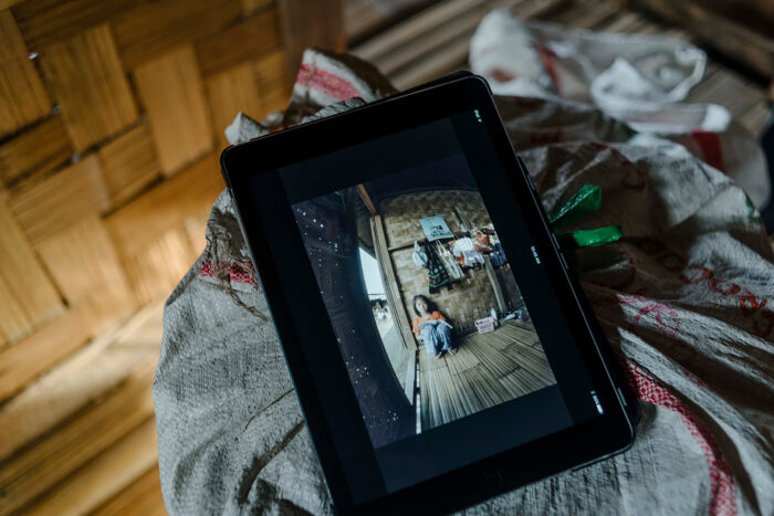 Tablet screen shows a scene from virtual reality documentary ‘The Price of Conflict, The Prospect of Peace’.