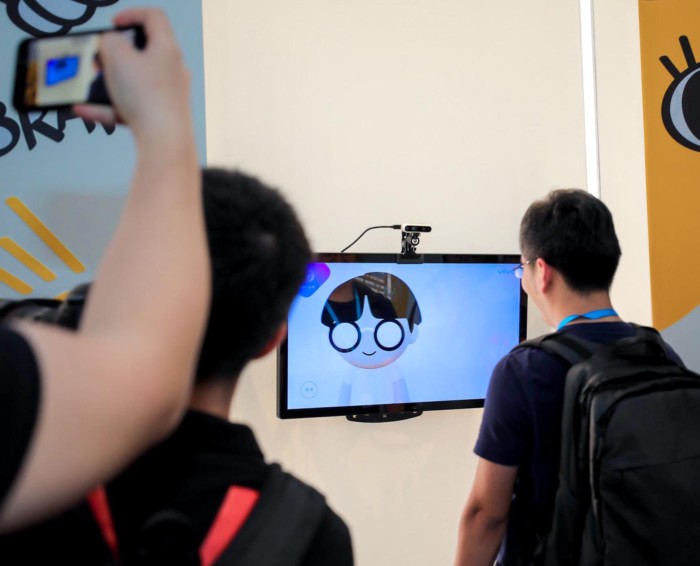 Man stands in front of a screen as the Vivo Me avatar generator uses facial recognition to create a personalised character.