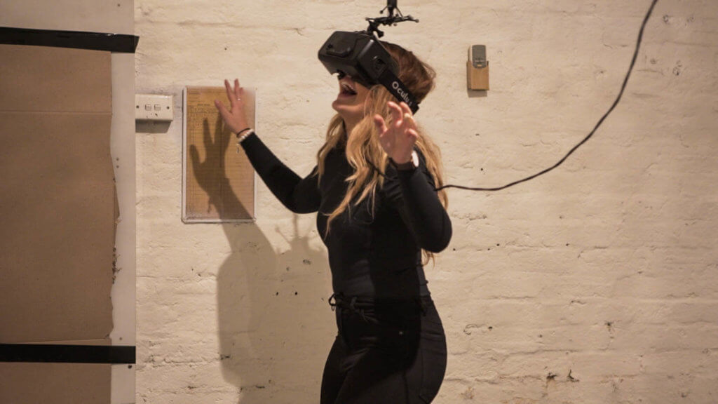 Girl experiencing virtual reality through HTC Vive and Optitrack