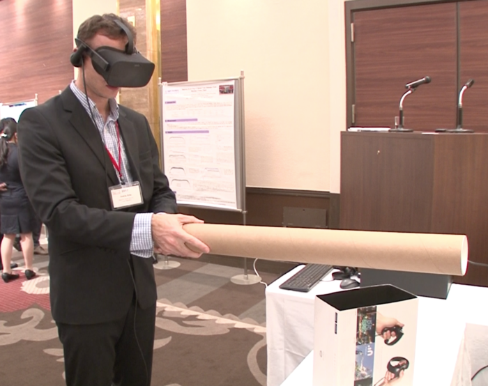 Man in a virtual reality headset interacts with objects in VR at the HOTLAB 2017 conference.