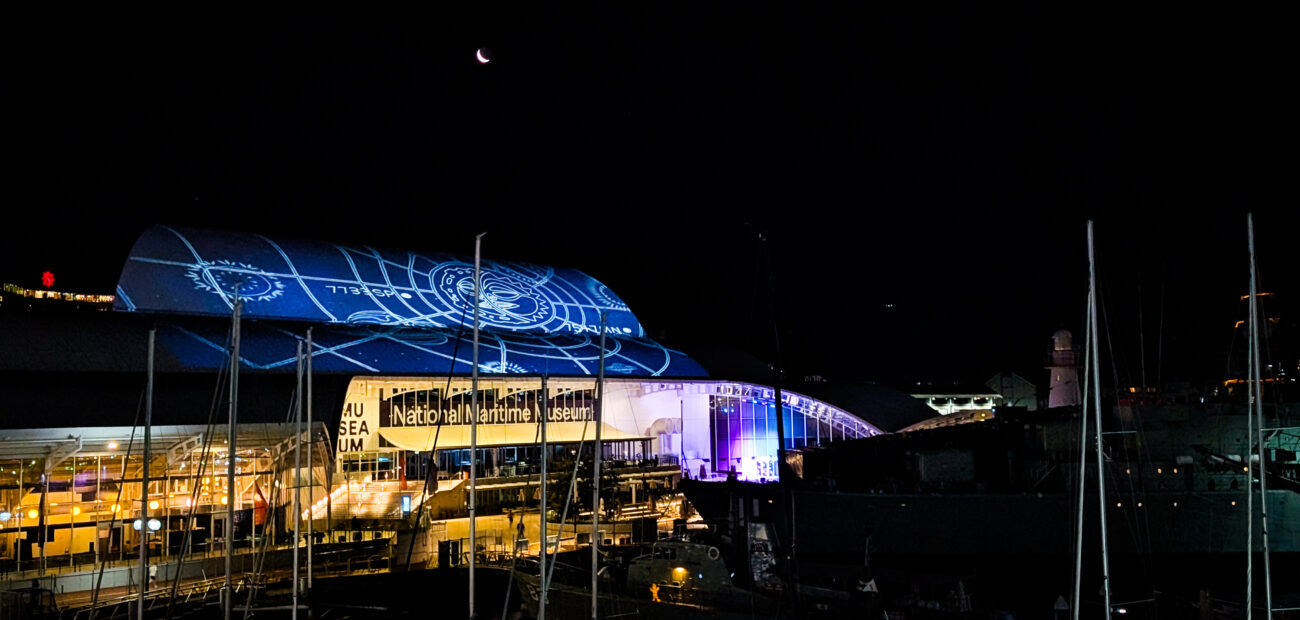 Onsite photo of S1T2 and Brian Robinson artistic projection on Maritime Museum roof for Vivid Sydney 2026.