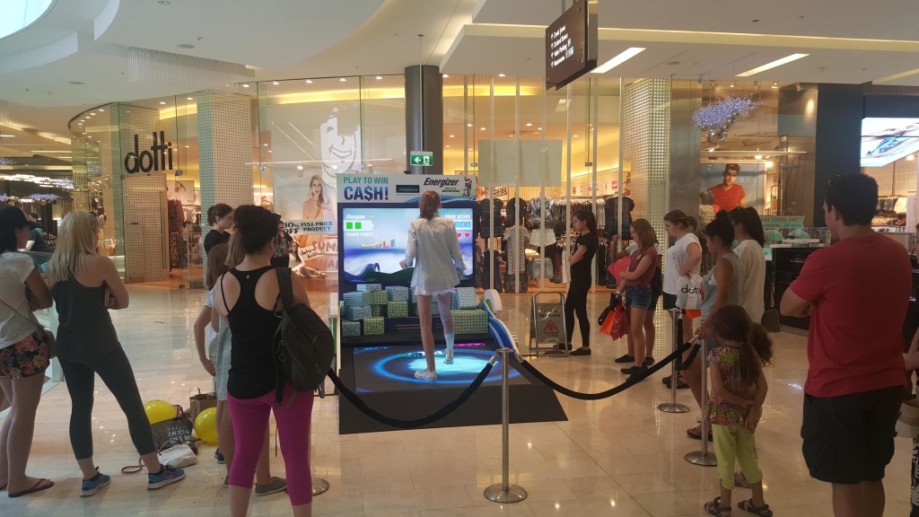 Crowd gathering around interactive LED floor Technology.