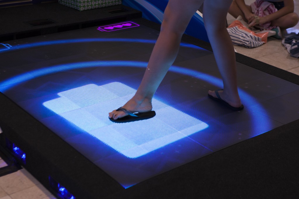 LED interactive floor with players feet interacting with game.